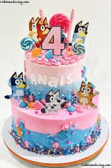 Bluey Theme Birthday Cake #bluey #bingo #bandit #chilli #rusty #muffin #blueybirthday #blueycake #blueybirthdayparty #sprinkles #candymelts #lollypops #fun #pinkandbluebutte